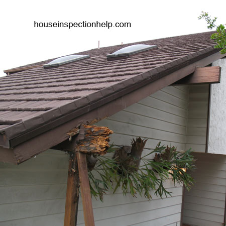 brown wood roof fascia board with bad water damage